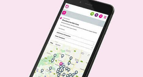 A mobile phone showing a map with pinpointed locations on the recycling locator