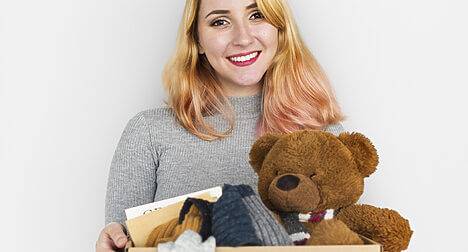 photo of woman with box of items for disposal