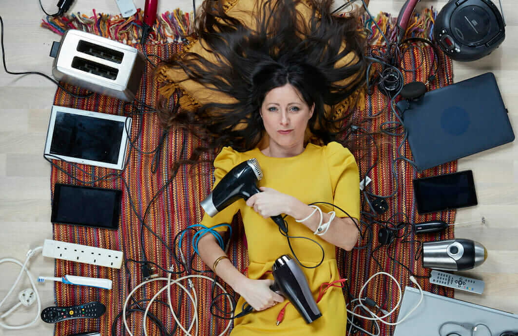 Natalie Fee, lying among electricals, by Gregg Segal