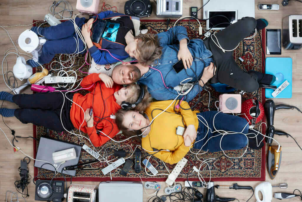 photo of man and children lying among electricals, by Gregg Segal