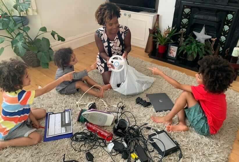 young family sorting unwanted electricals for recycling