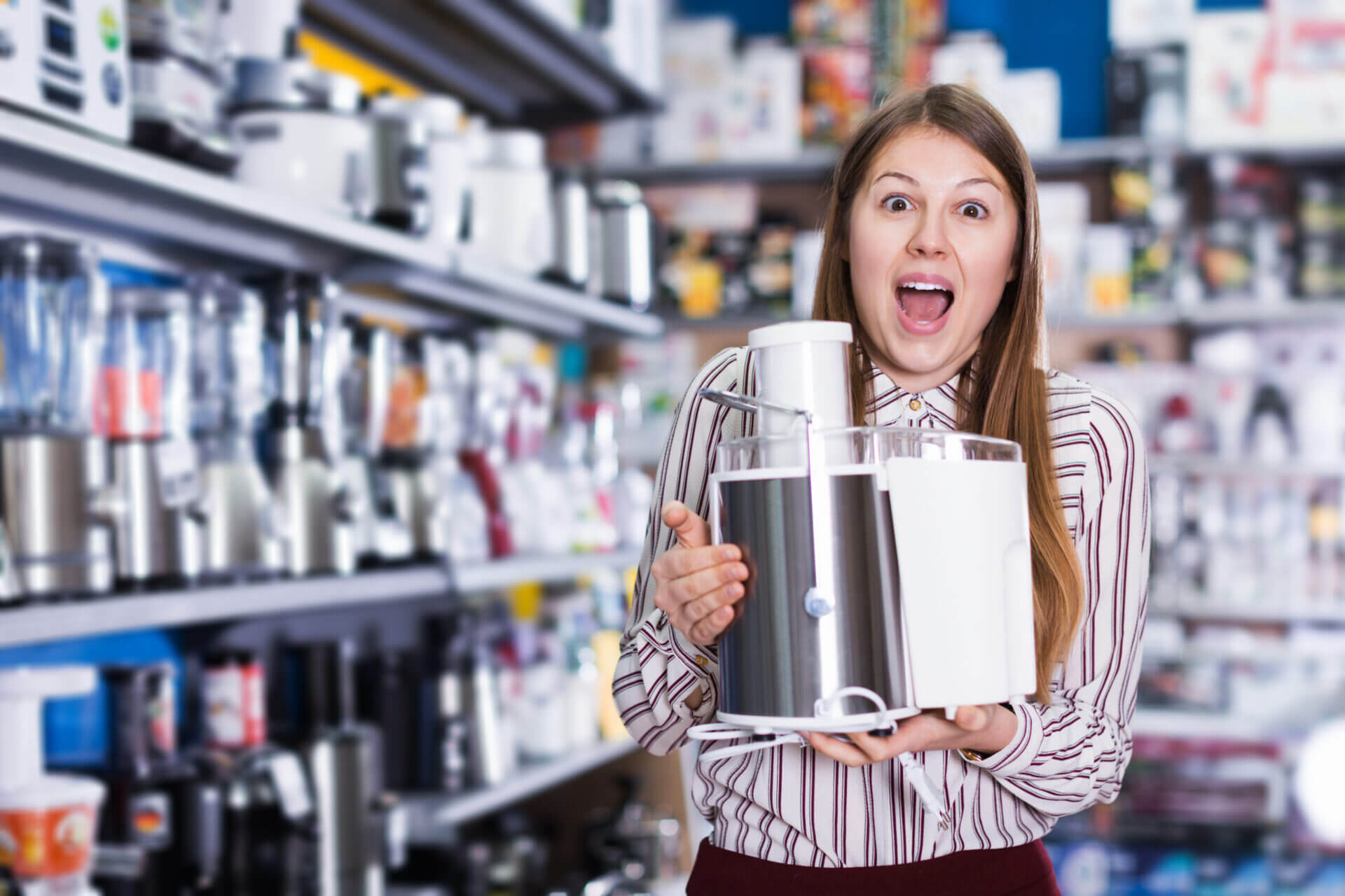 Electrical appliance recyclin is getting easier: Woman in electrical store holding food mixer