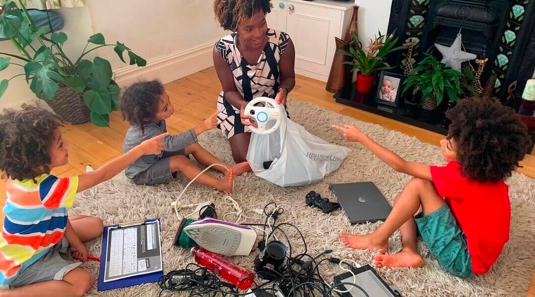 Young family sorting electricals to recycle