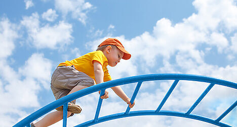 child on climbing frame - playground equipment can be made from materials salvaged from recycled electricals