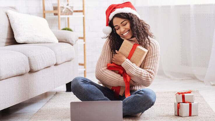 A woman holds a christmas gift