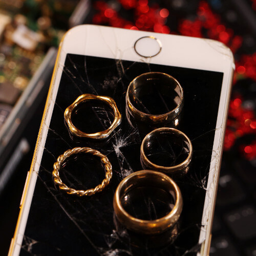 Gold rings placed on a mobile phone