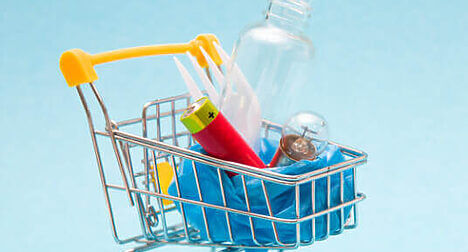 supermarket trolley with mixed recycling in it