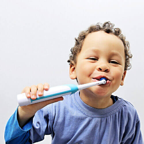 boy with electric toothbrush