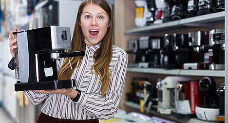 person in shop with coffee machine