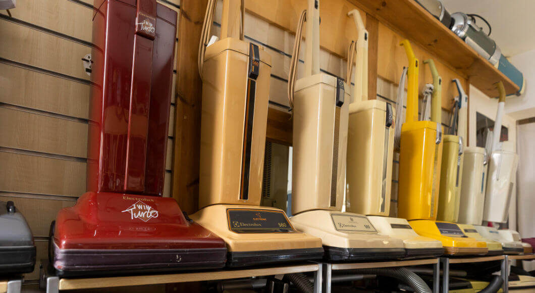 A shelf of vacuum cleaners