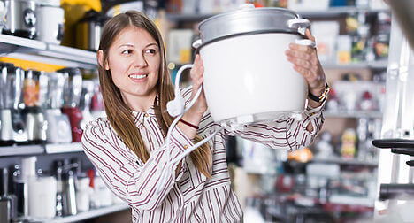 person with slow cooker in store