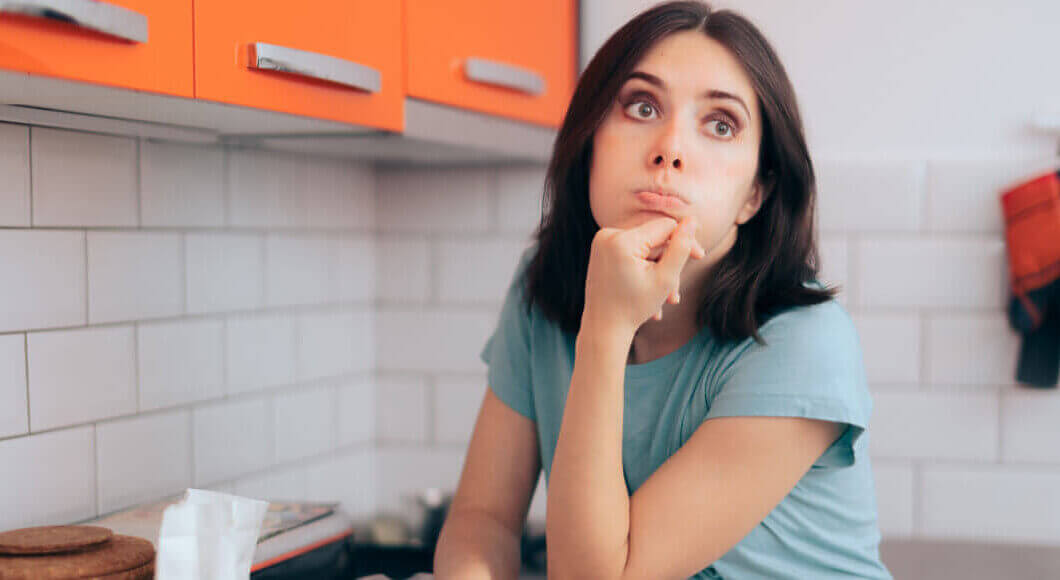 a bored woman in a kitchen