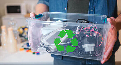 person holding box of electricals for recycling