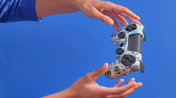 hands with games controller made from origami bank notes