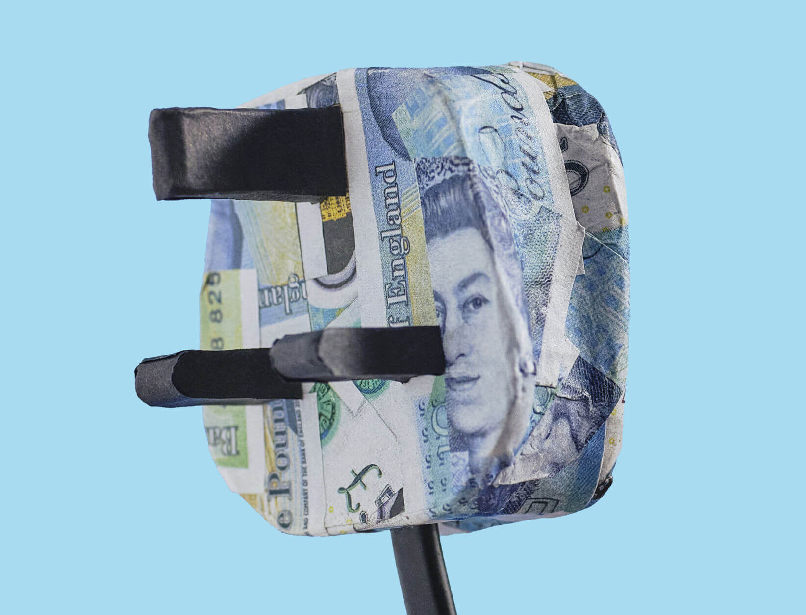 a three pin plug that has been papier mached with five pound notes