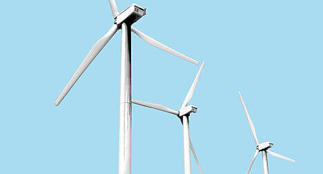 Wind turbines against a blue background