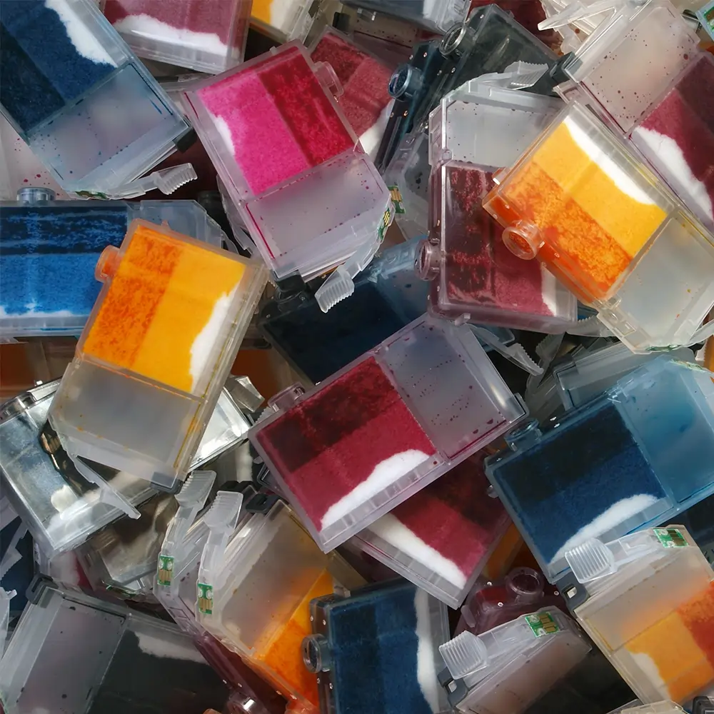 close up on a pile of multicoloured printer cartridges