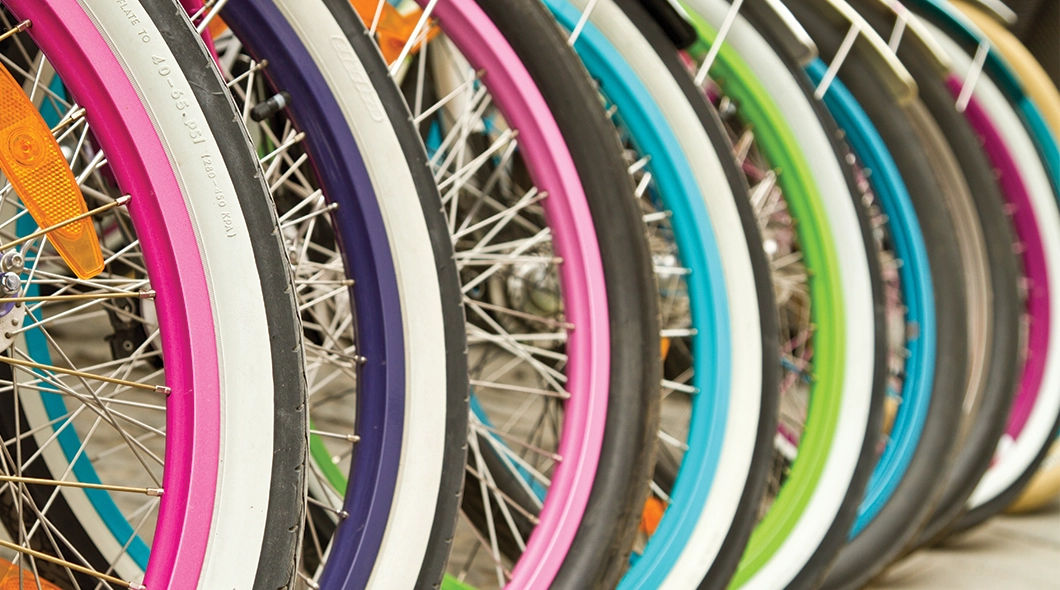 close up of many brightly coloured bicycle wheels