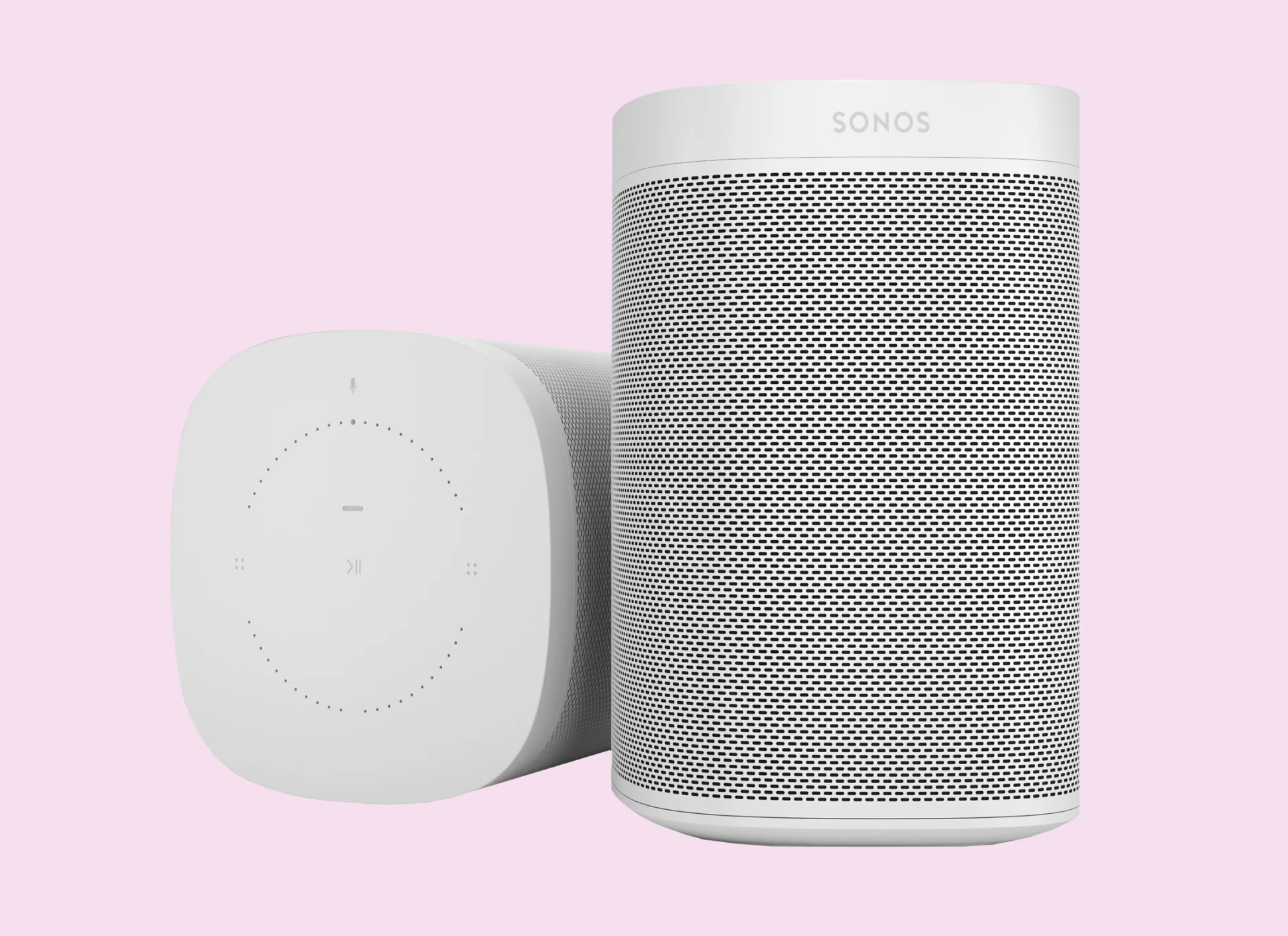 grey modern speakers against a pale pink background